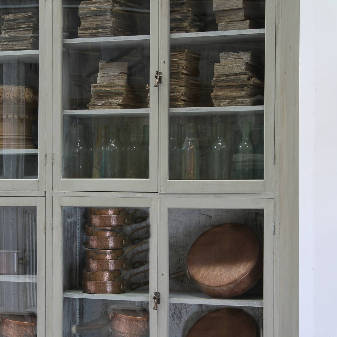 A close up cropped view of the doors with copper pans